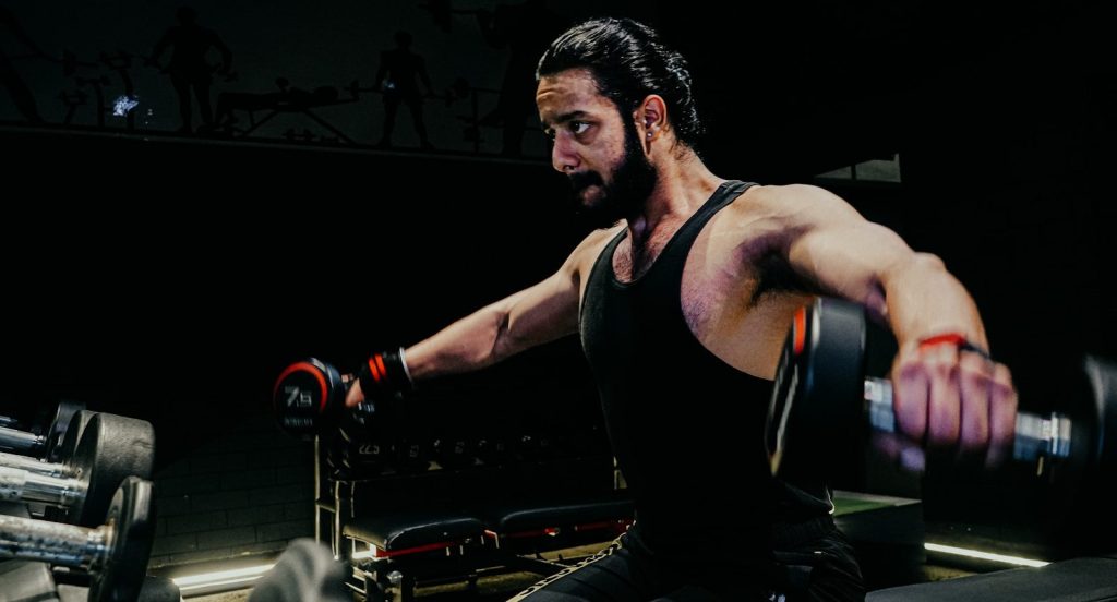 a man with a barbell in a gym