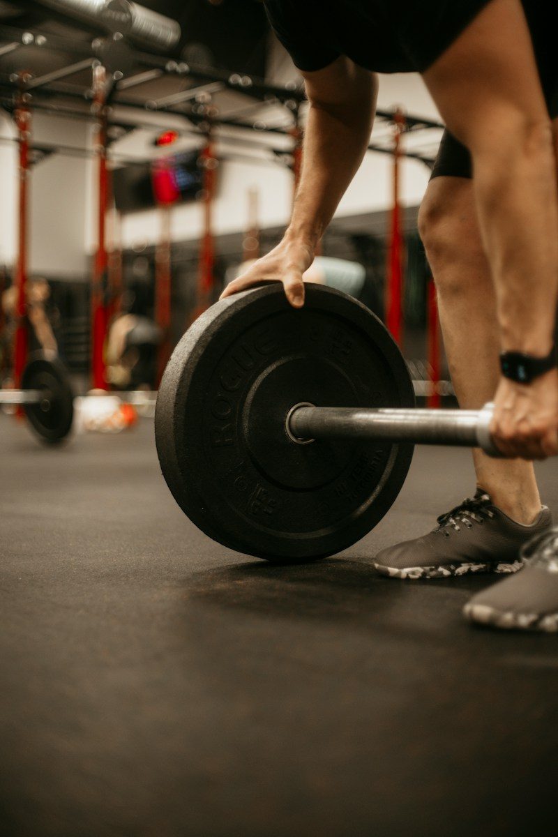 a man lifting a barbell in a gym