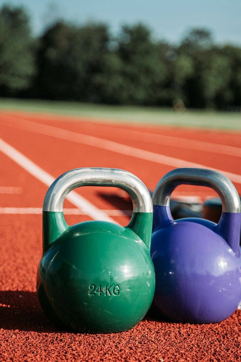 two green and purple kettle bells